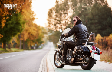Man on a motorcycle parked on the side of the road