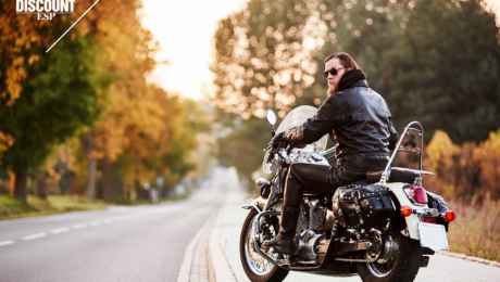 Man on a motorcycle parked on the side of the road